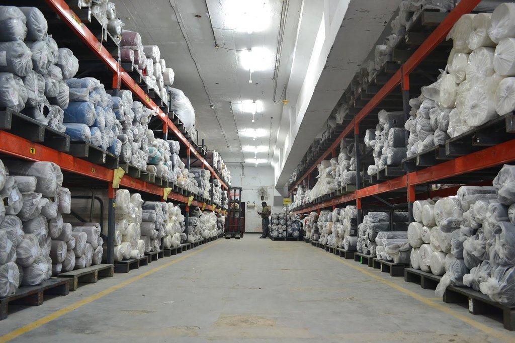 The raw material store, fabric racked and labelled by roll
